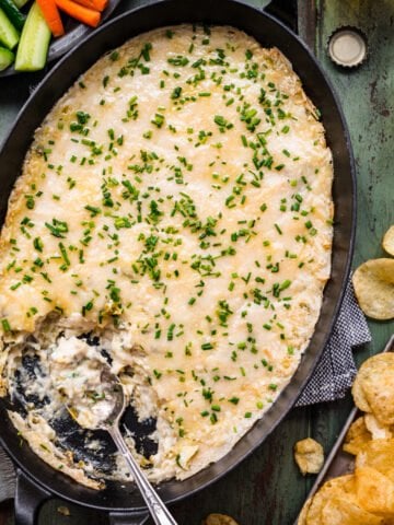 Overhead view of spinach artichoke dip in a pan.