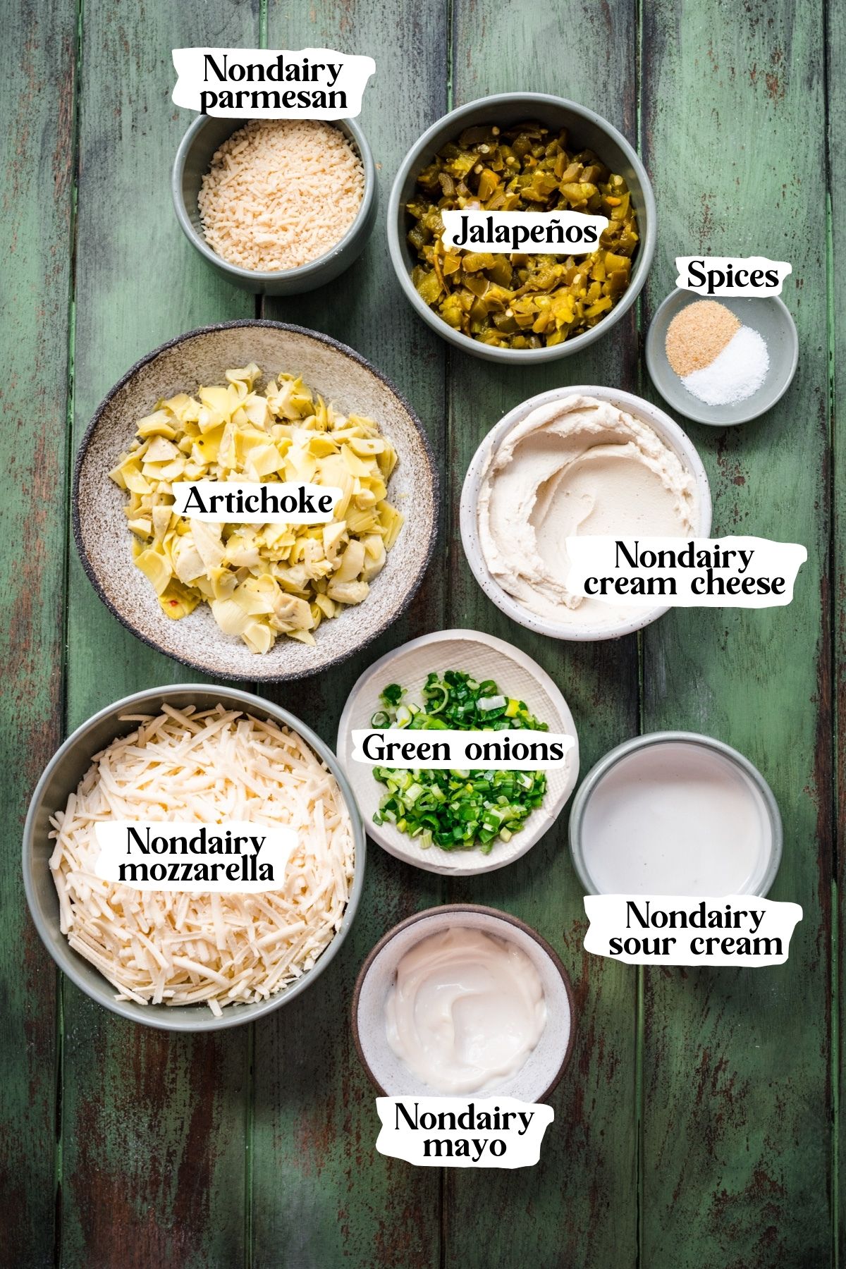 Overhead view of artichoke jalapeño dip ingredients, including nondairy mayo and sour cream.