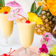 Front view of pina colada mocktail with pineapple and cocktail umbrella.