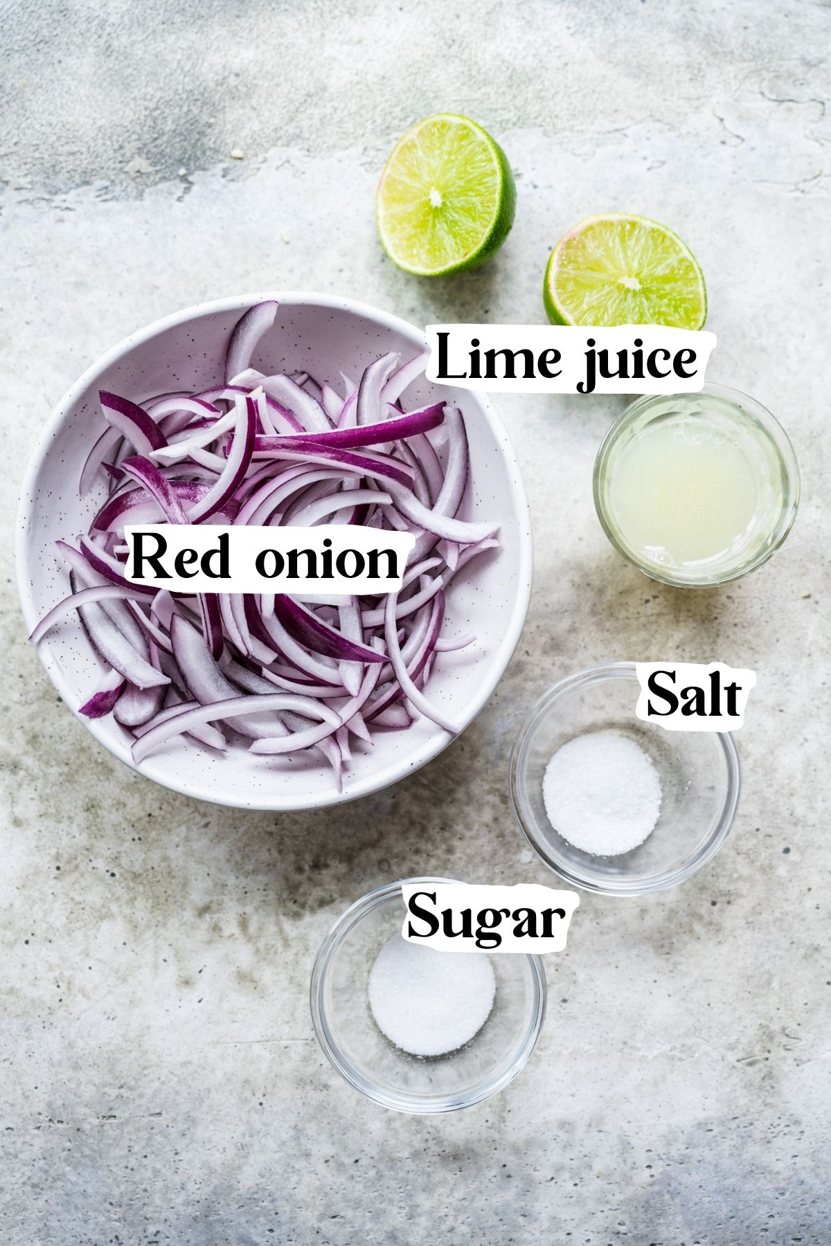 Overhead view of quick pickled red onion ingredients, including red onion, lime juice, salt and sugar.