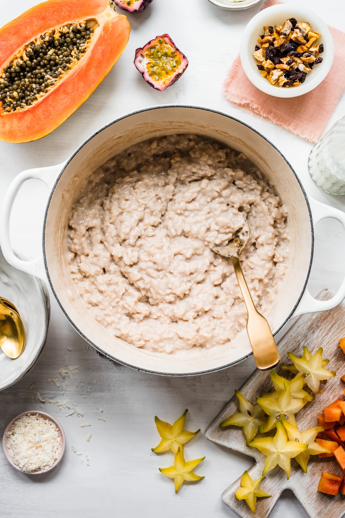 Overhead view of rice pudding in a bowl surrounded by 