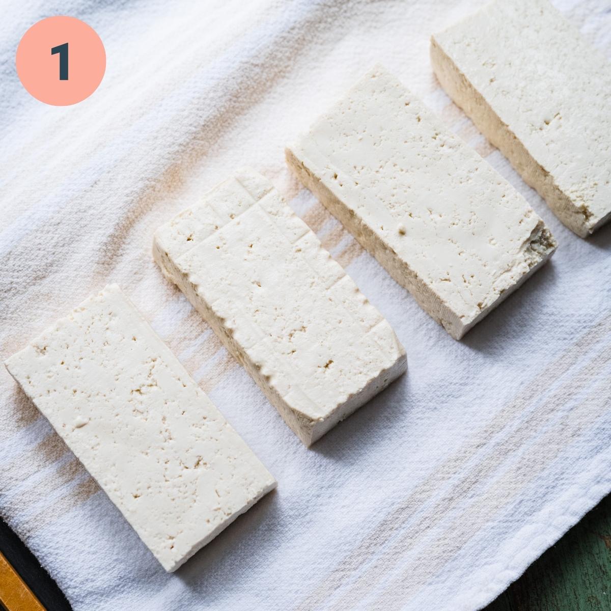 pressed tofu on tea towel.