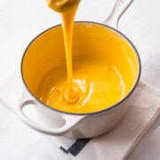 Overhead view of cheese sauce in a saucepan.