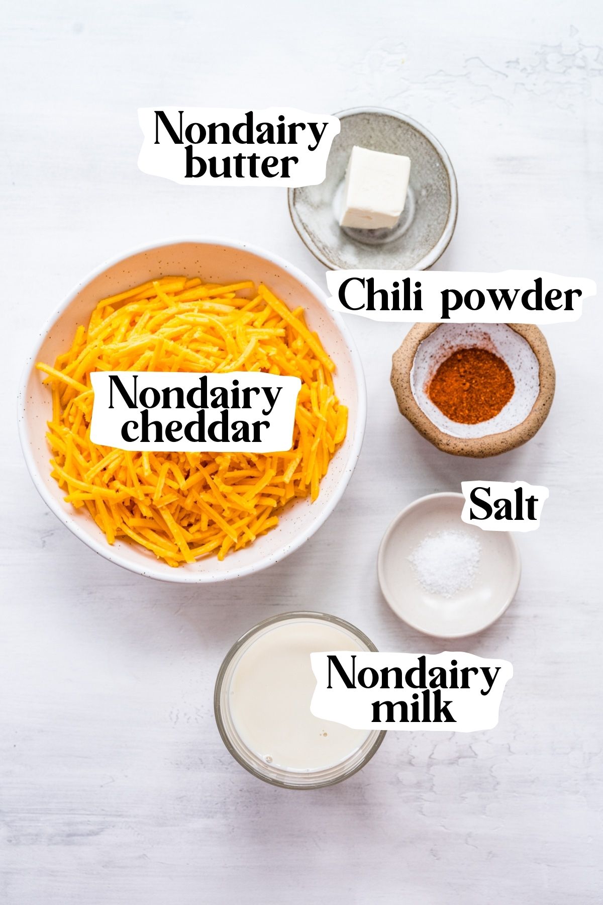 Overhead view of vegan cheese sauce, including nondairy cheddar and chili powder.