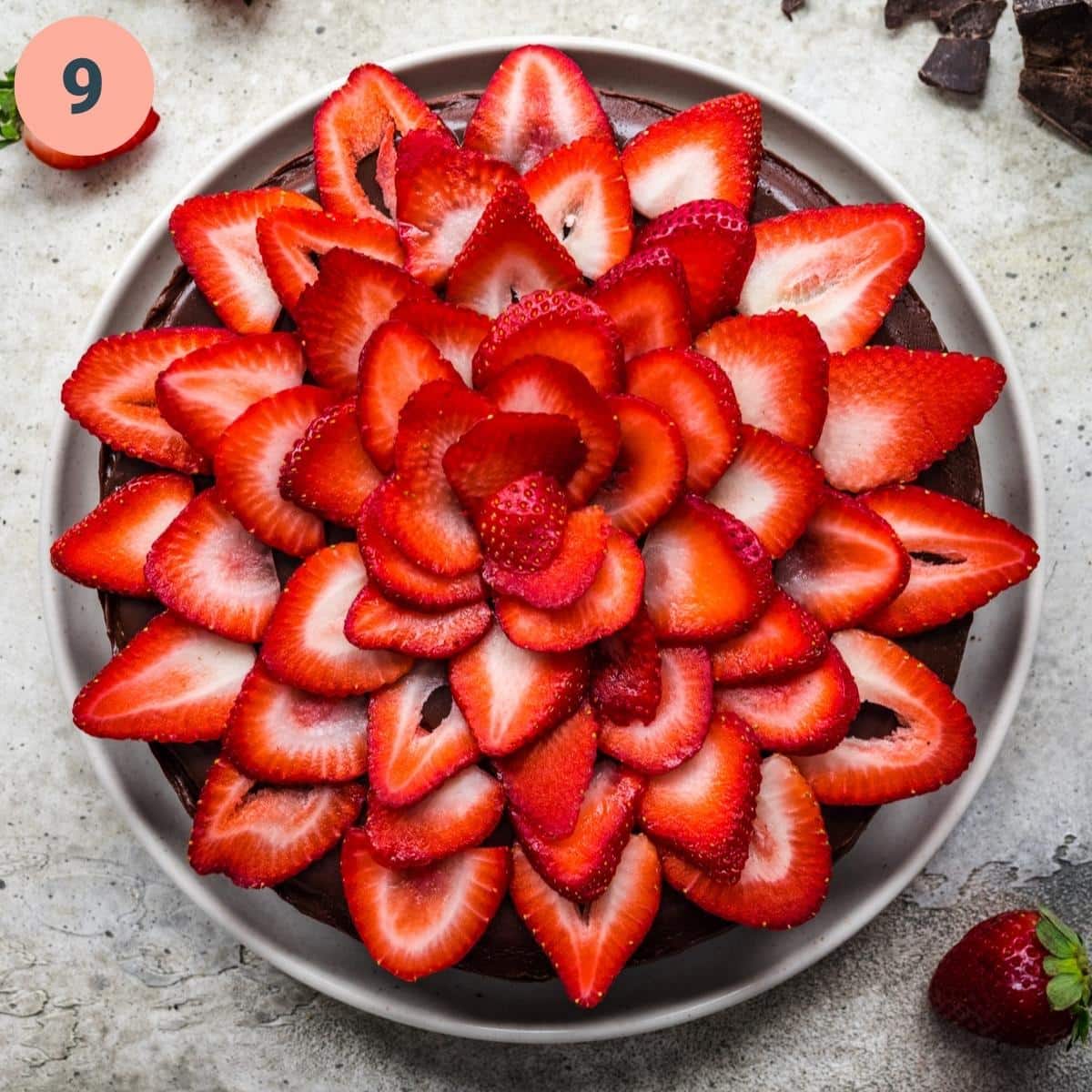 vegan chocolate cheesecake topped with fresh sliced strawberries. 