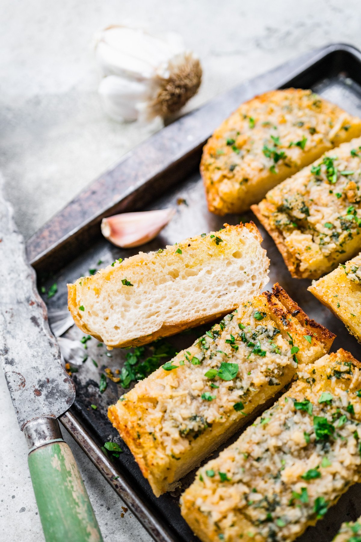 Front view of garlic bread on a pan.