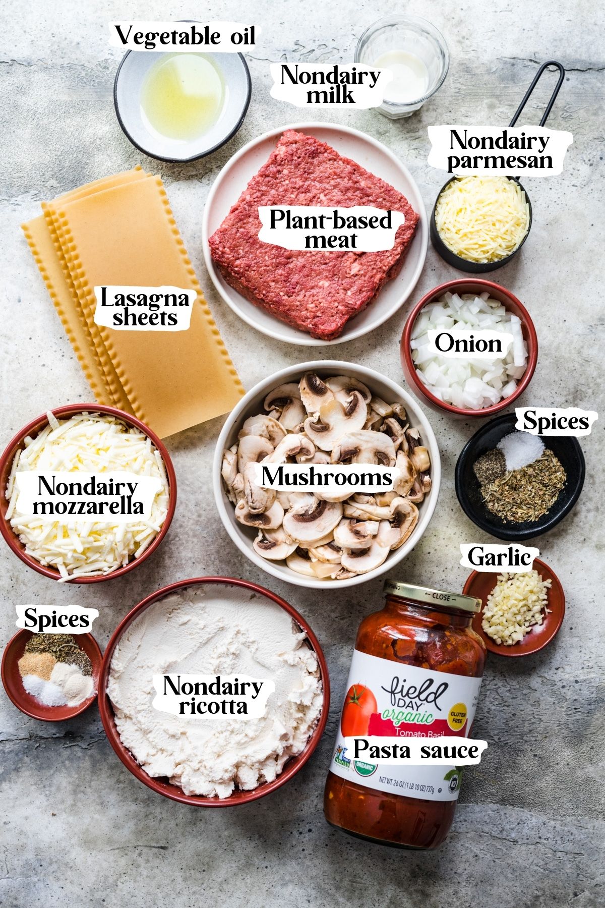 Overhead view of vegan lasagna ingredients, including plant-based meat and cheeses.
