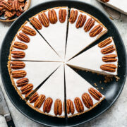 Overhead view of white chocolate cheesecake with pecans around the rim.