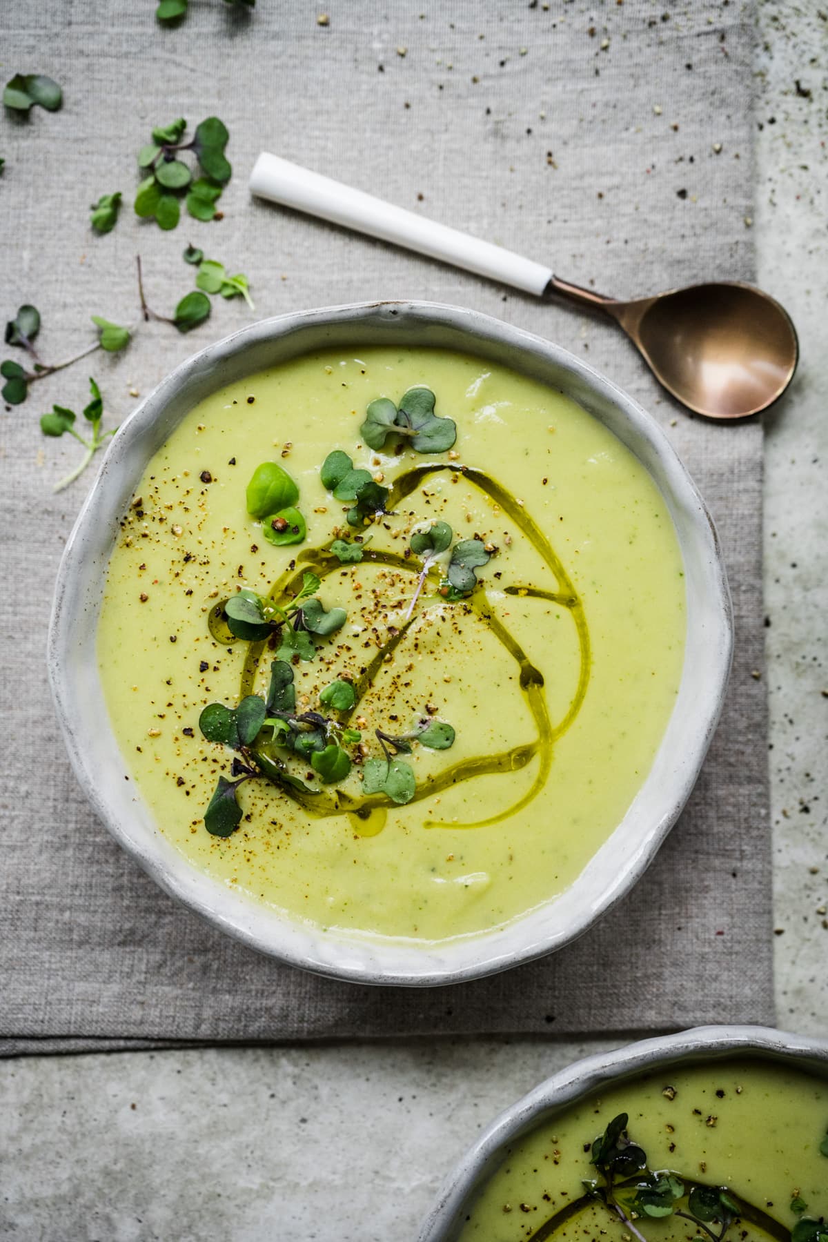 Overhead view of cauliflower leek soup in a bowl.