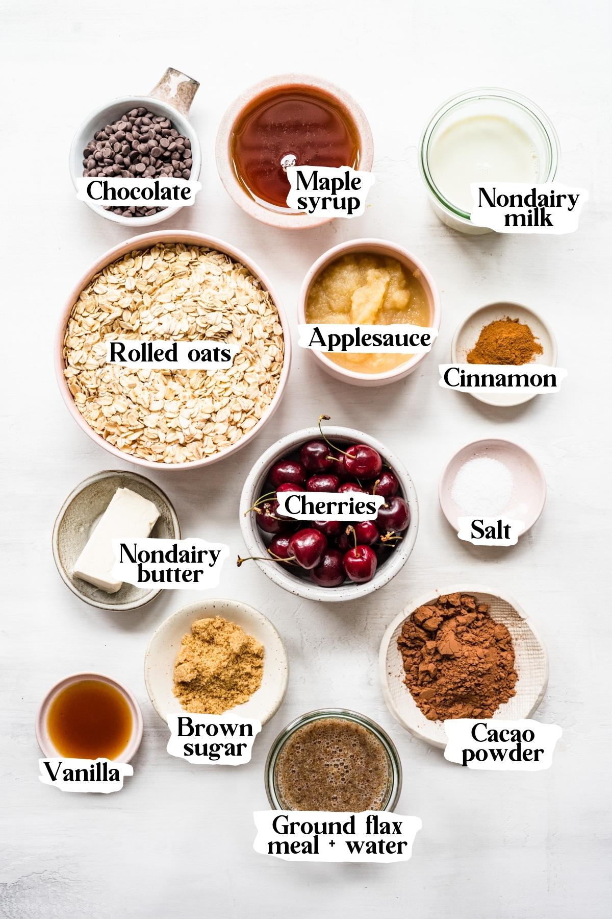 overhead view of ingredients for chocolate cherry baked oats in small prep bowls. 