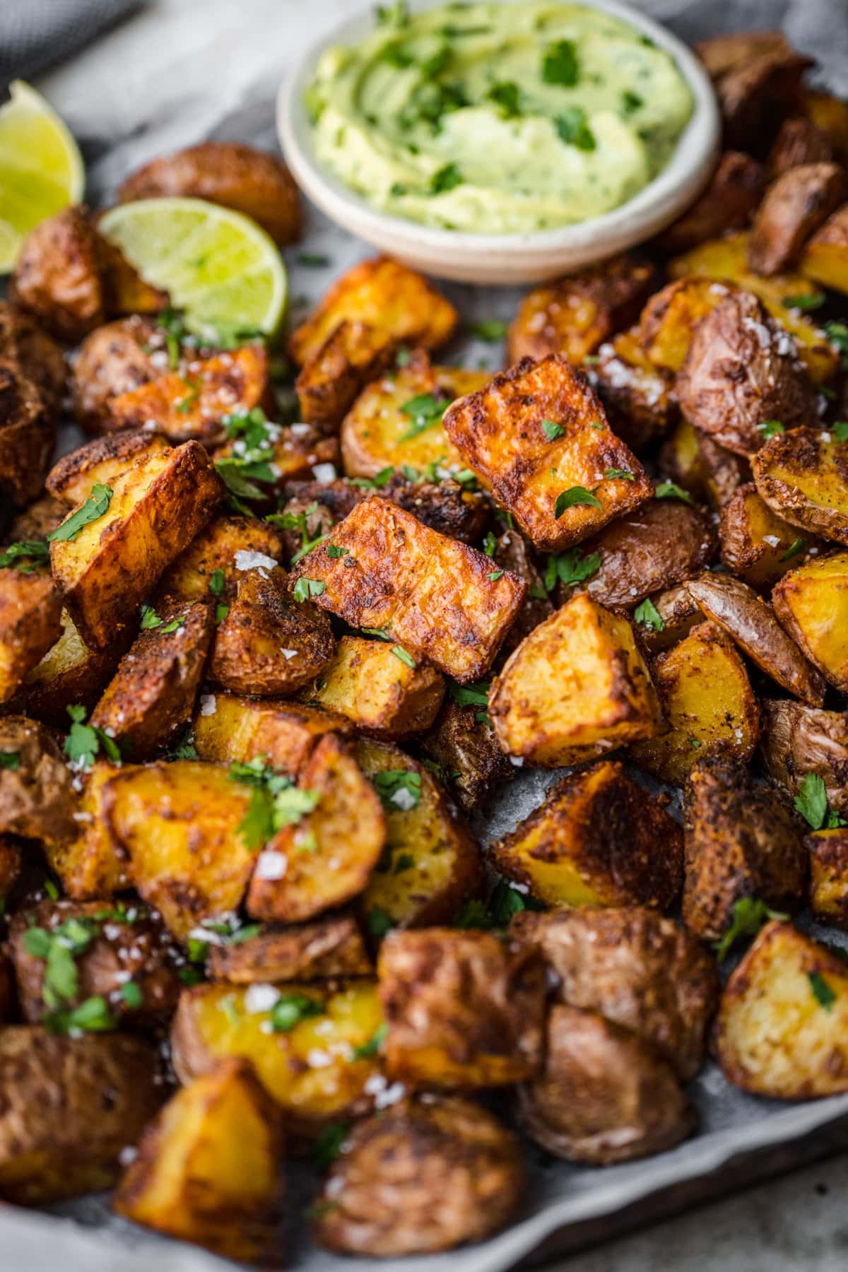 Close up view of crispy roasted potatoes on a sheet pan. 