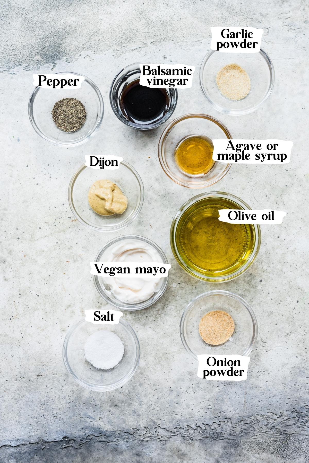 Overhead view of creamy balsamic dressing ingredients, including balsamic vinegar and dijon mustard.