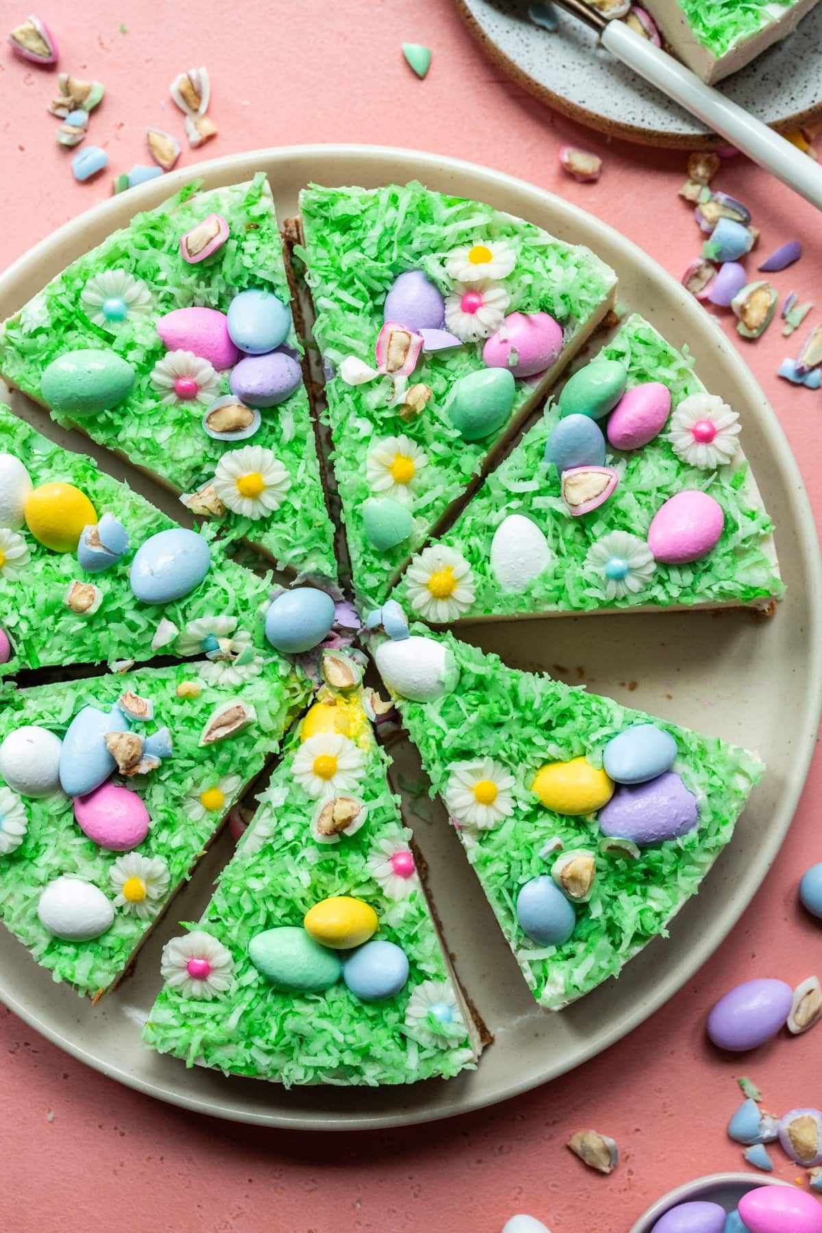 Overhead view of vegan no bake easter egg cheesecake sliced on plate.