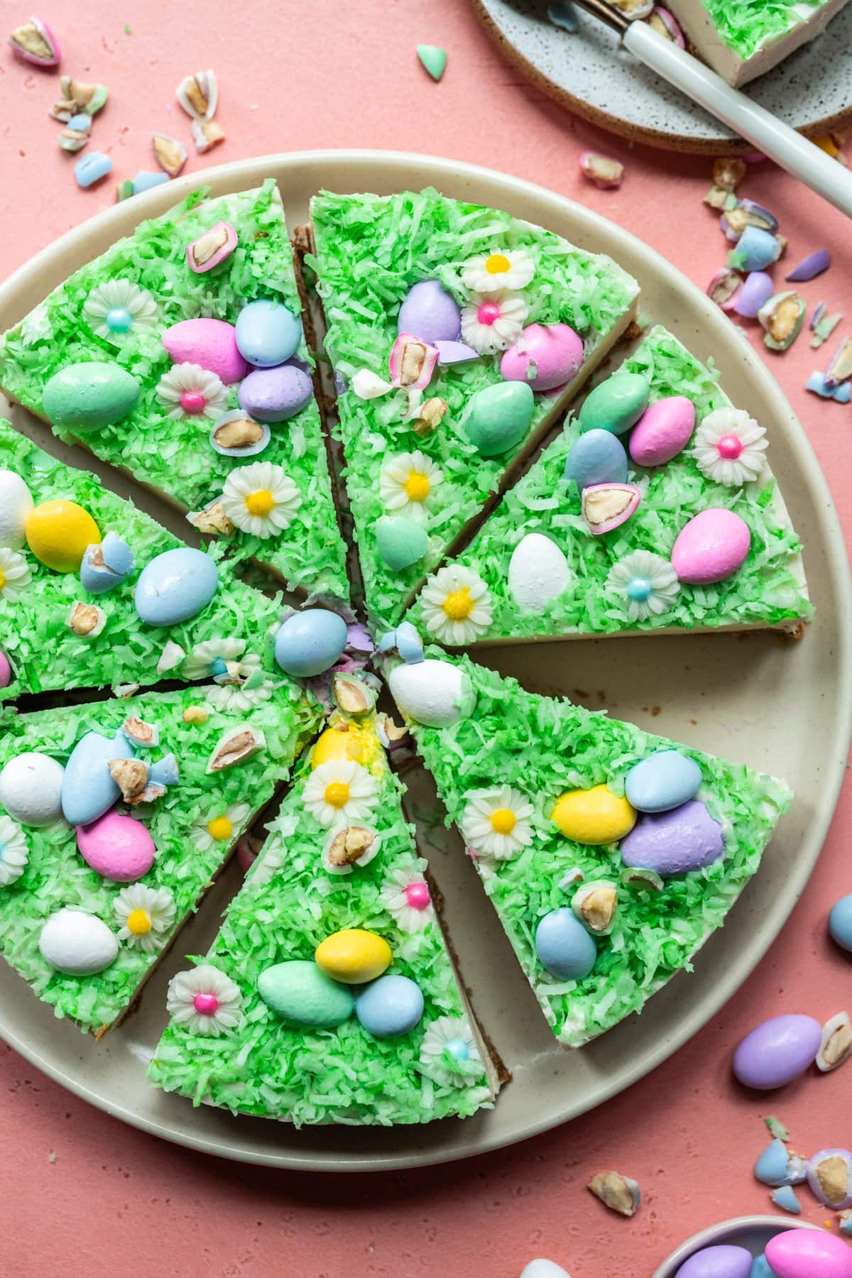 Overhead view of vegan no bake easter egg cheesecake sliced on plate. 