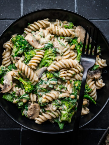 Overhead view of hummus pasta with veggies.