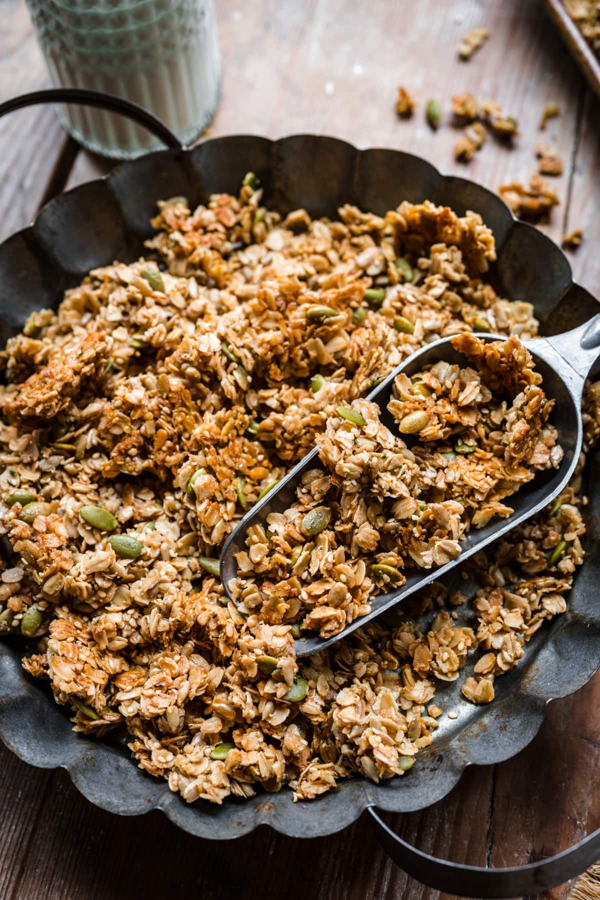 Overhead view of a bowl of nut free granola with a scooper.