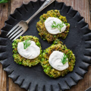 Overhead view of pea fritters with lemon dill sauce on top.