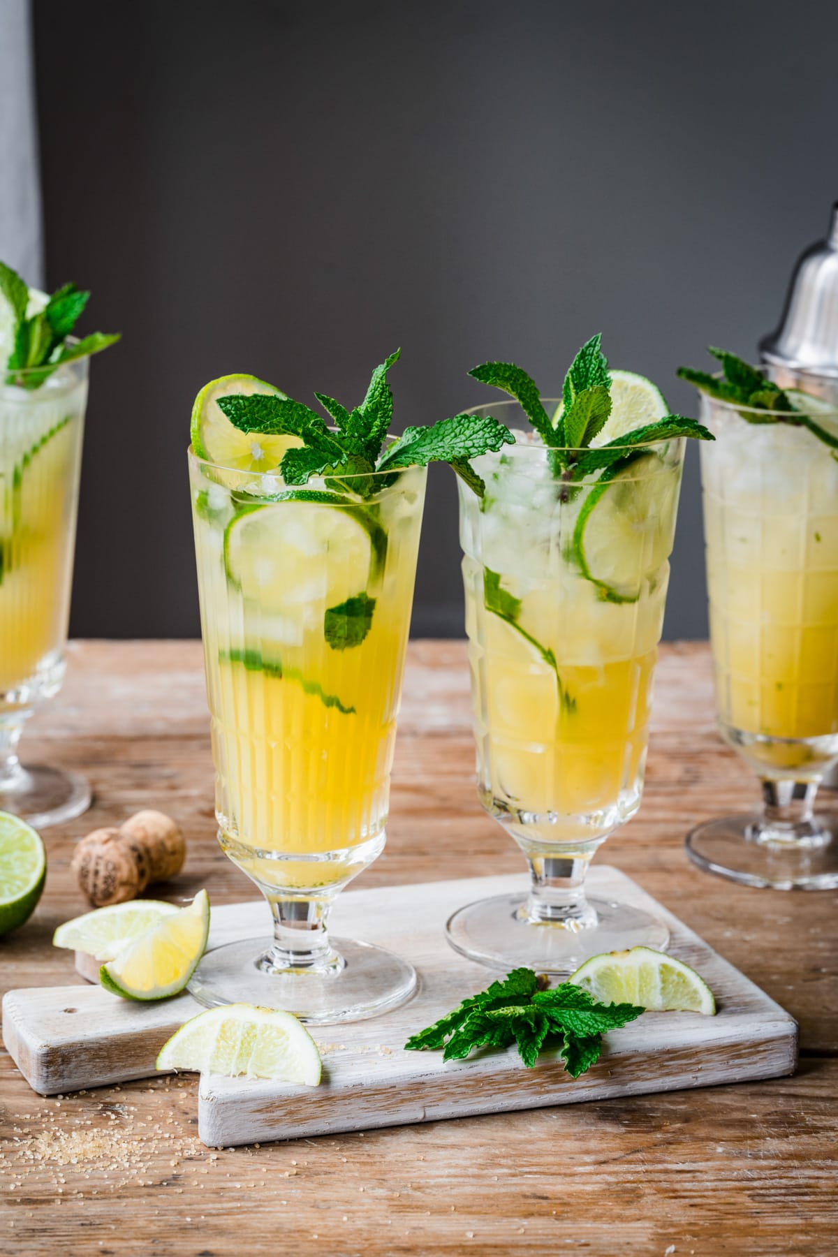 Side view of 2 pineapple mojito cocktails in highball glasses with mint garnish. 