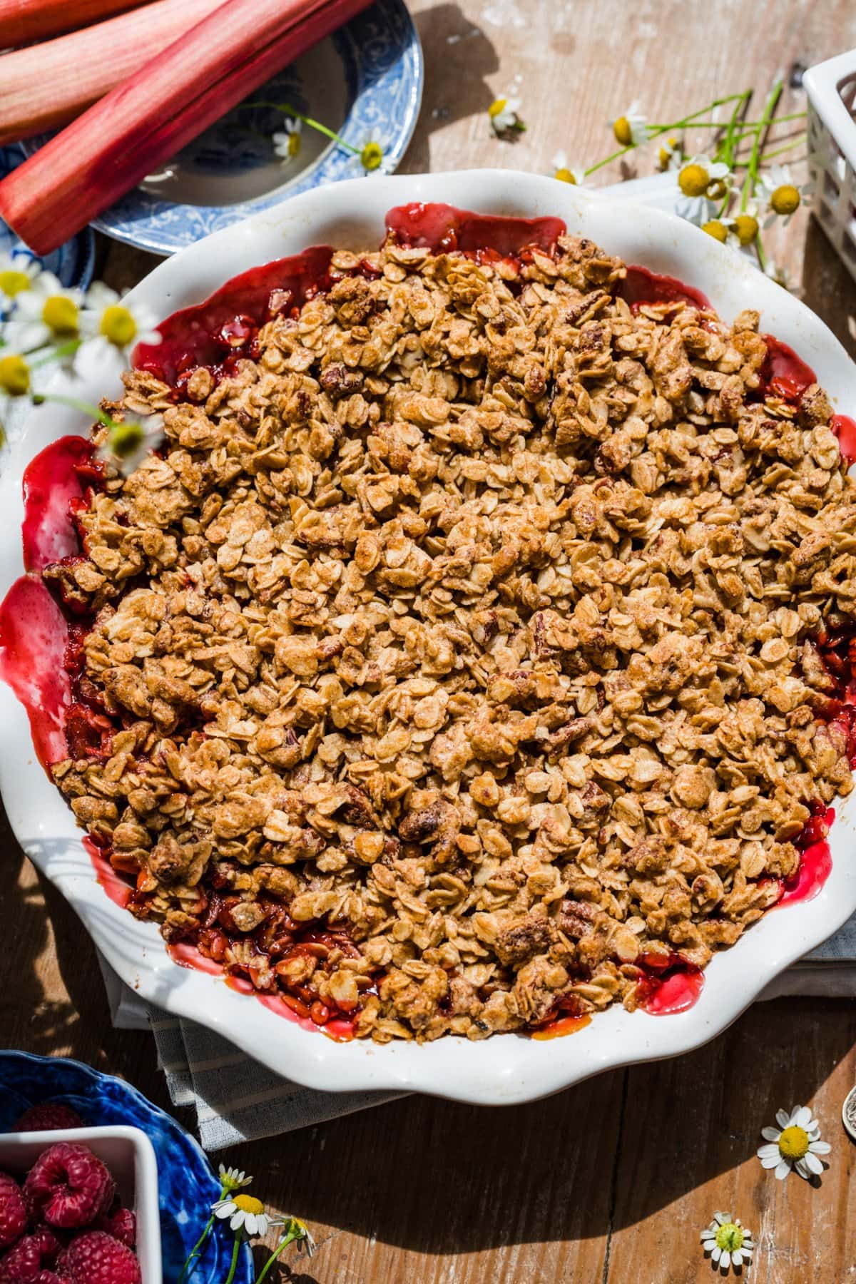 strawberry rhubarb crisp on wood table. 