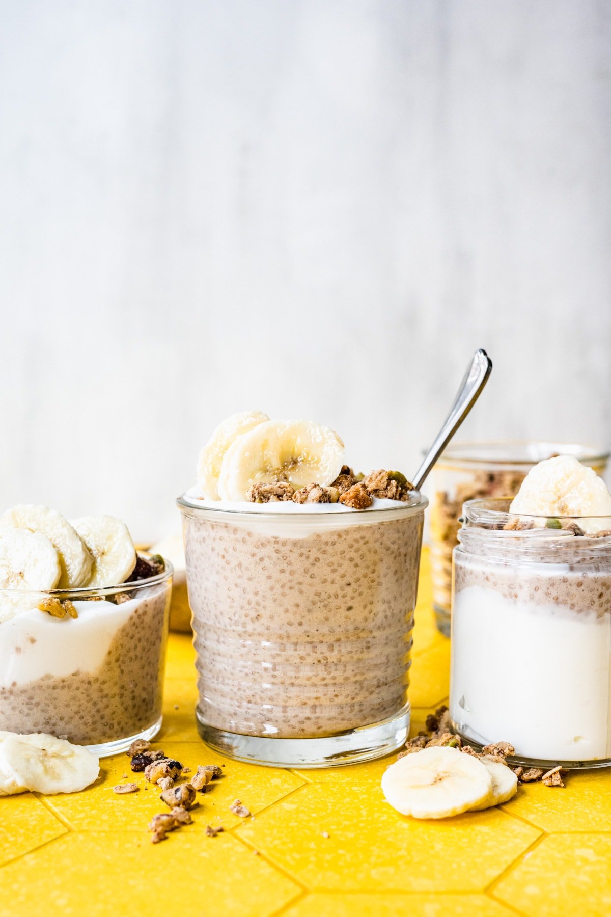 Front view of banana chia pudding with a spoon in it.