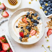 Close up image of finished berry granola on yogurt in bowl.