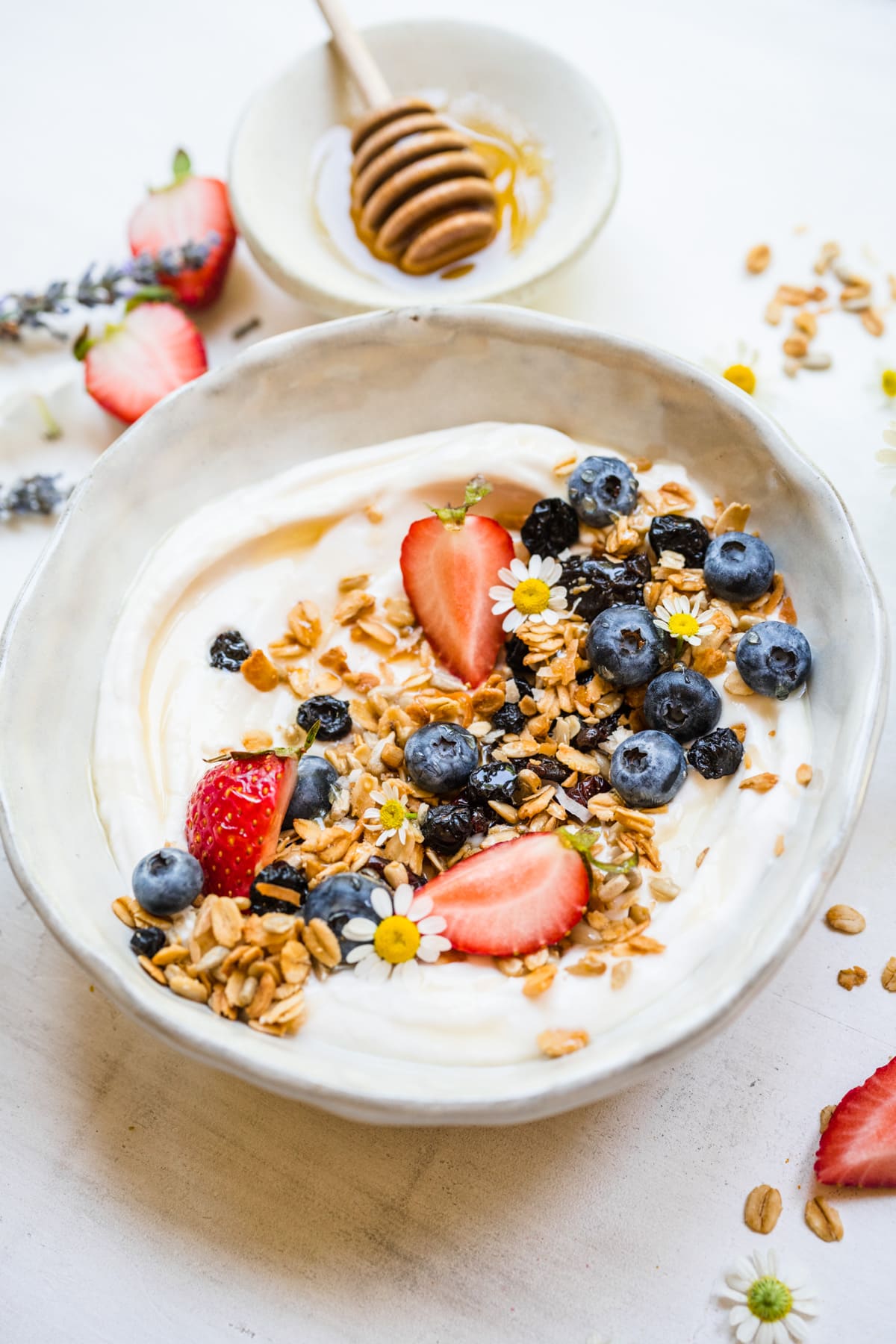 Close up view of finished granola on top of yogurt in bowl.