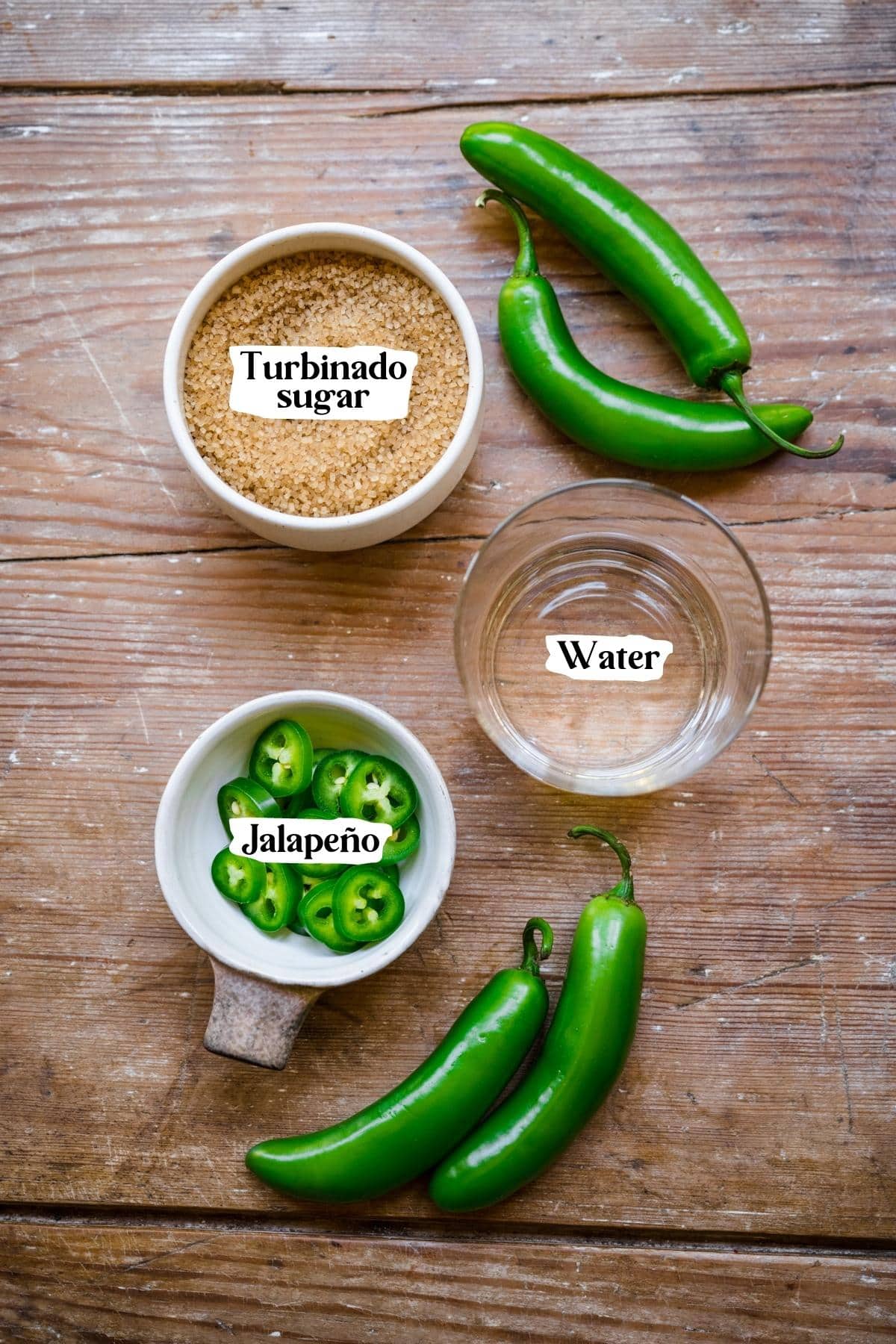 Overhead view of jalapeno simple syrup ingredients, including jalapeno, turbinado sugar, and water.