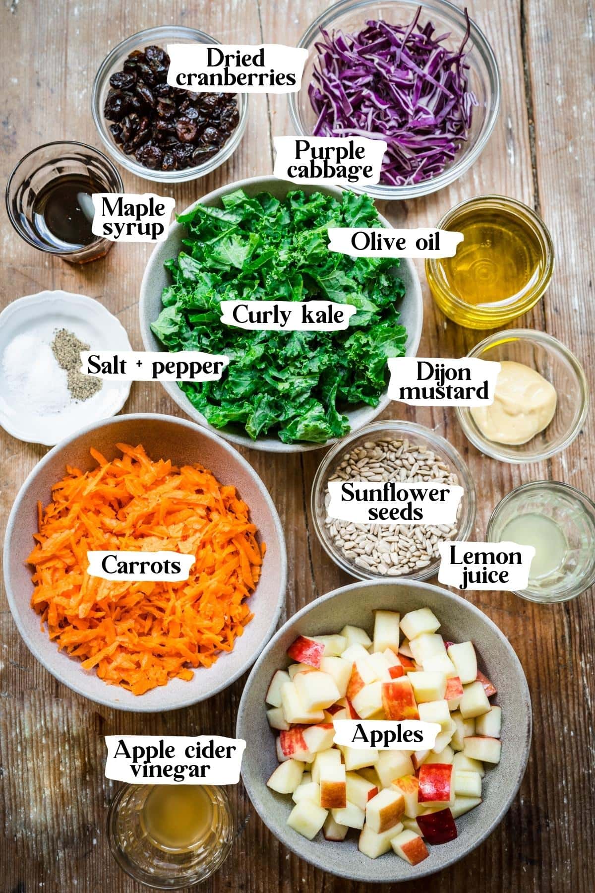 Overhead view of kale apple slaw ingredients, including kale and carrots.