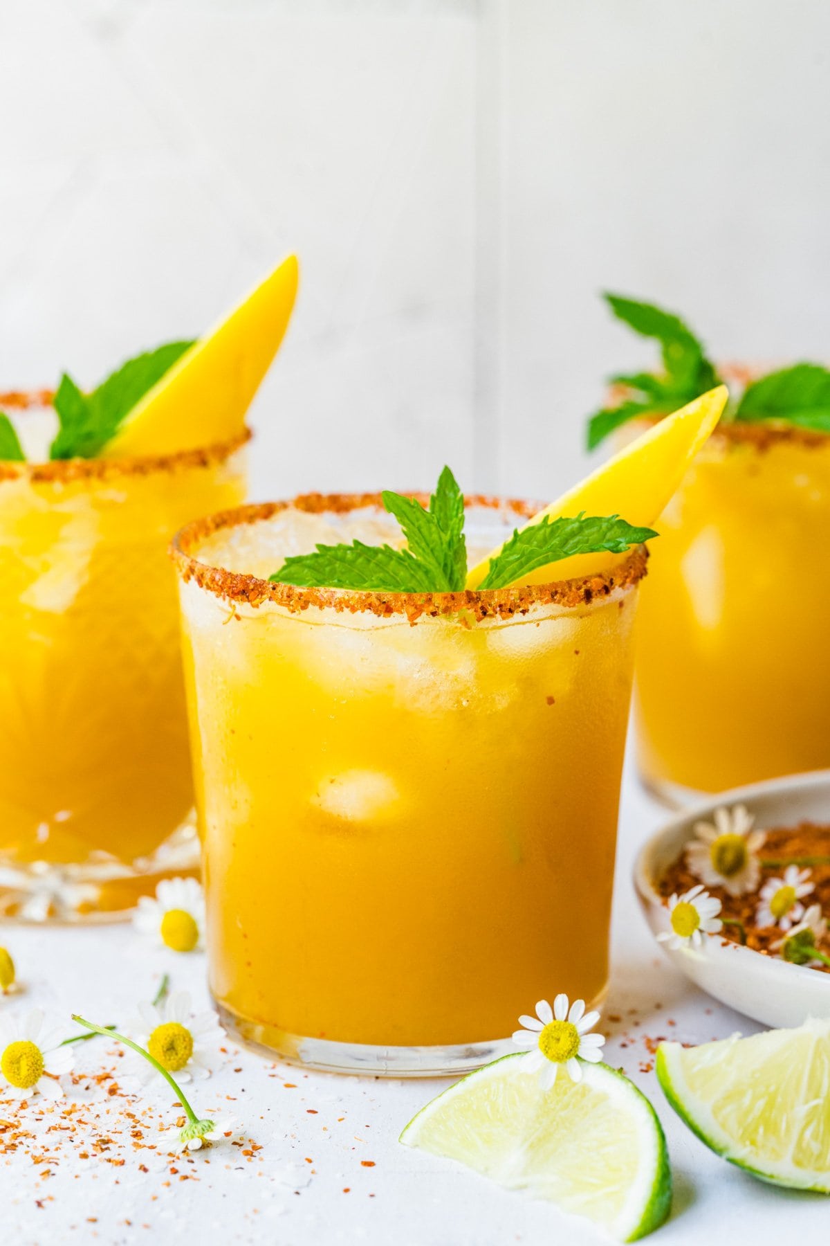 Close up of finished mango margaritas with garnish.