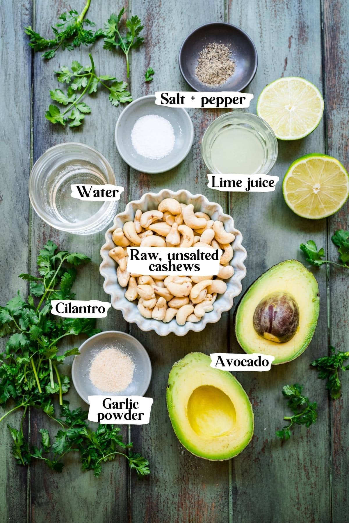 Overhead view of vegan avocado crema ingredients, including avocado and cashews.