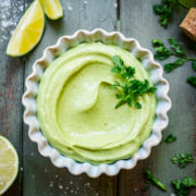 Overhead view of avocado crema in a ramekin.