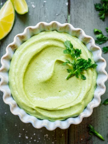 Overhead view of avocado crema in a ramekin.