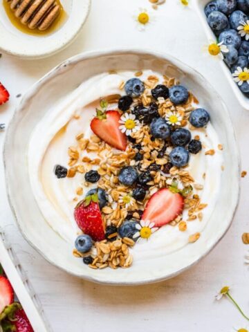 Close up image of finished berry granola on yogurt in bowl.