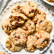 Close up of finished granola cookies on a white plate.