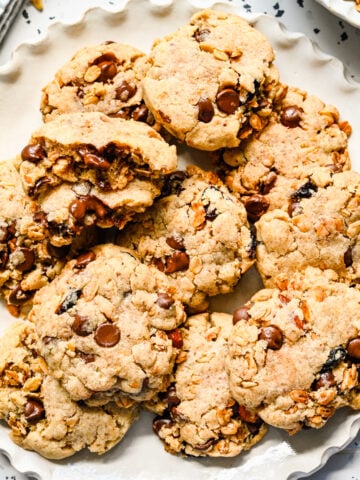 Close up of finished granola cookies on a white plate.