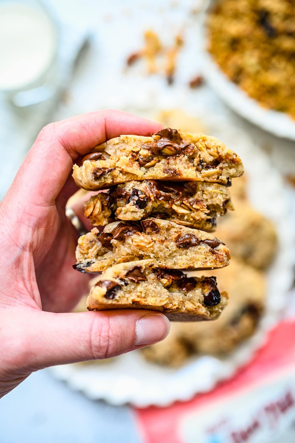 Finished granola cookies in a stack, bit in half.