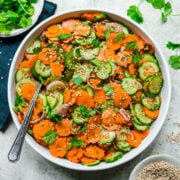 overhead view of carrot cucumber salad in white bowl.