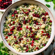 Close up of finished pomegranate couscous salad in a bowl.