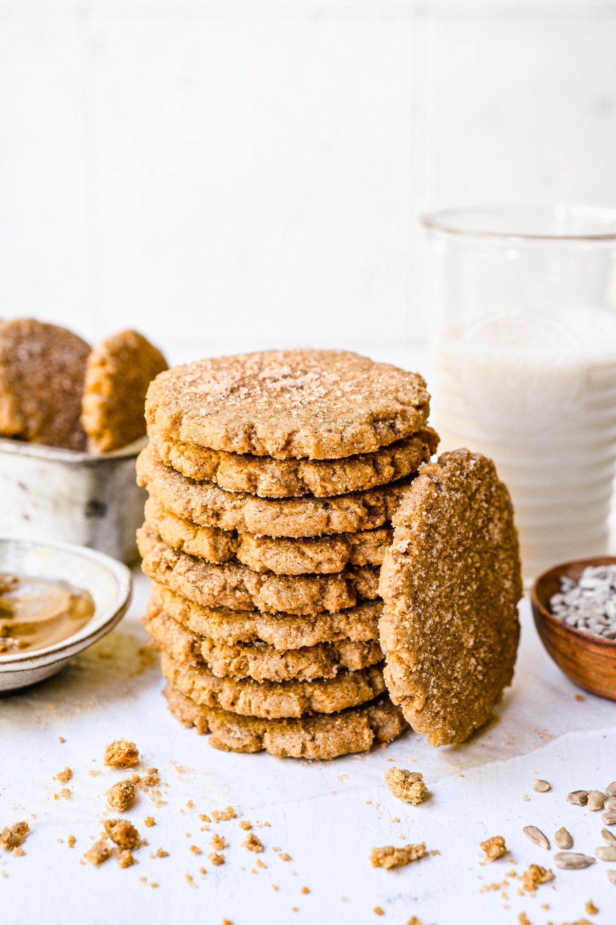 Close up of finished sunbutter cookies in a stack on white background.