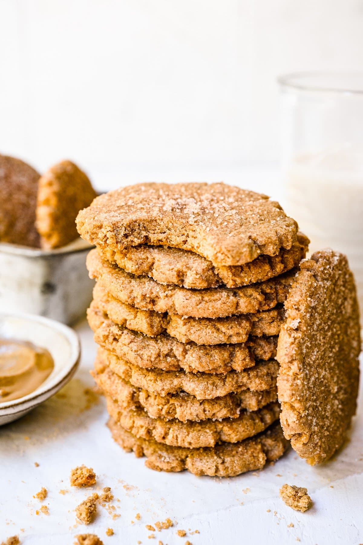 Stack of sunbutter cookies with a bite taken out of top one.