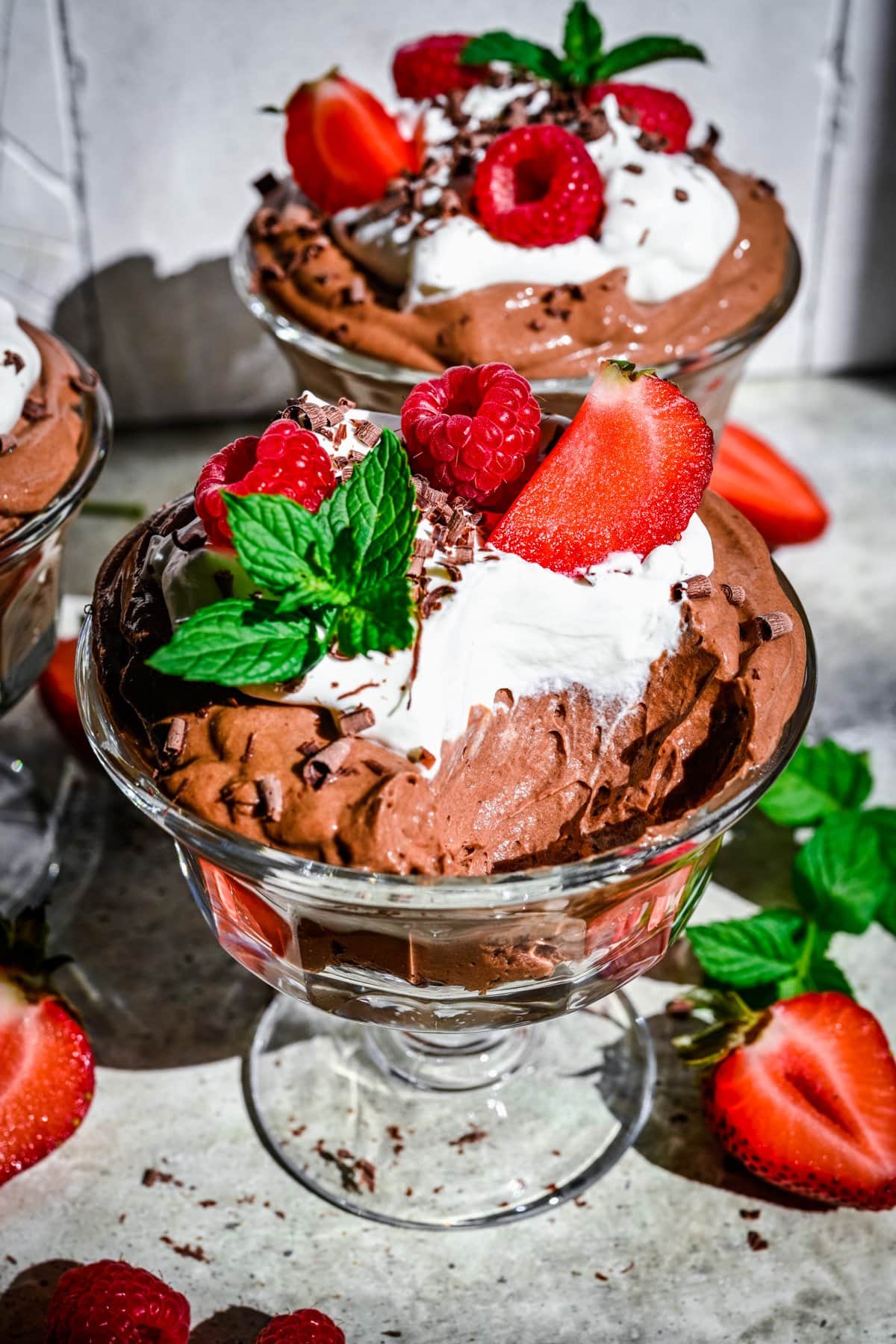 Close up view of tofu chocolate mousse in jar with spoonful taken out.