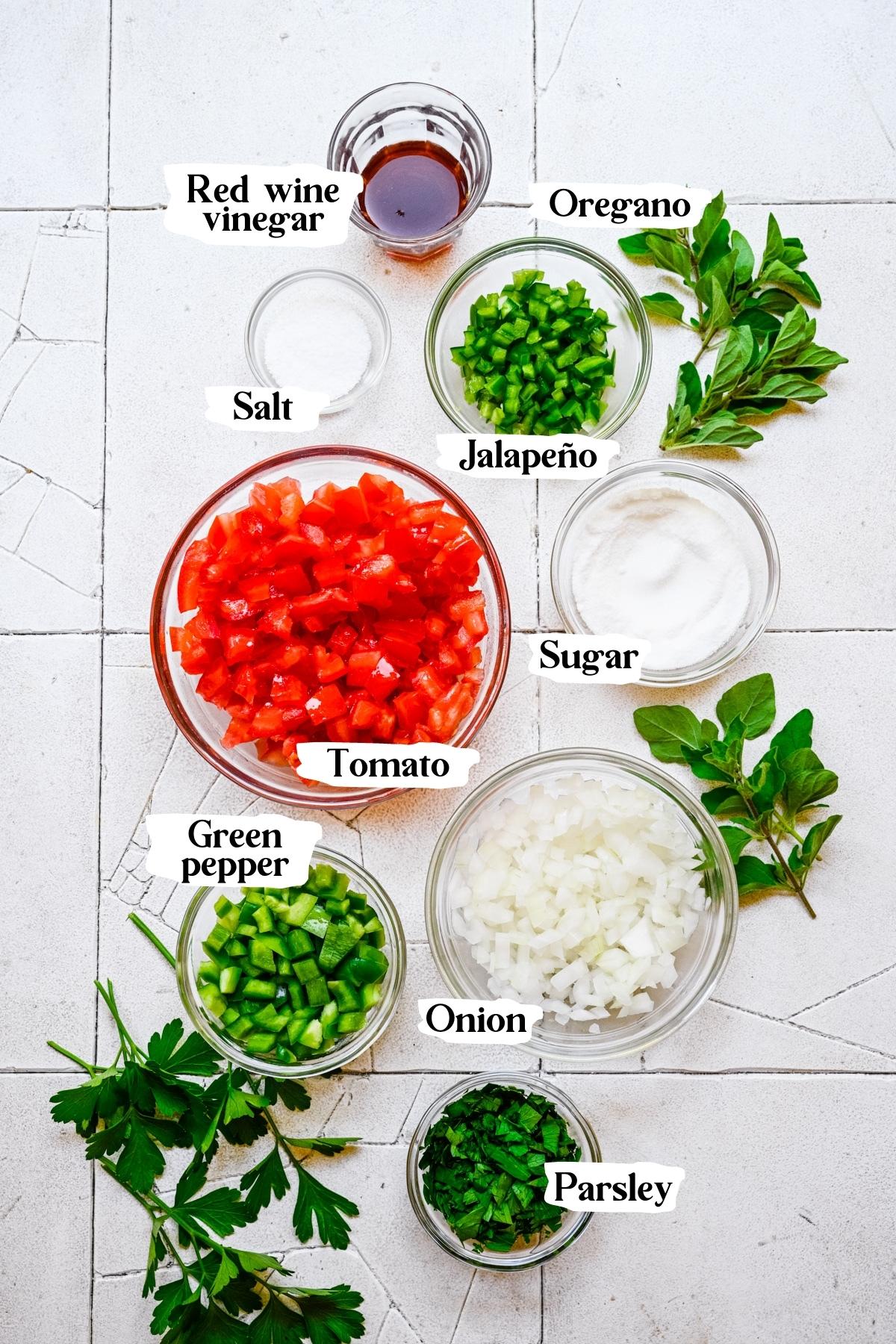 Overhead view of tomato relish ingredients, including tomatoes and onions.