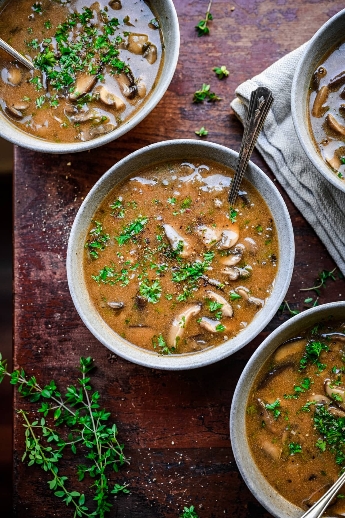 Overhead view of 3 bowls of vegan mushroom soup.