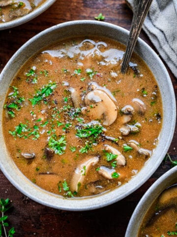 Close up of finished cream of mushroom soup served in a bowl.