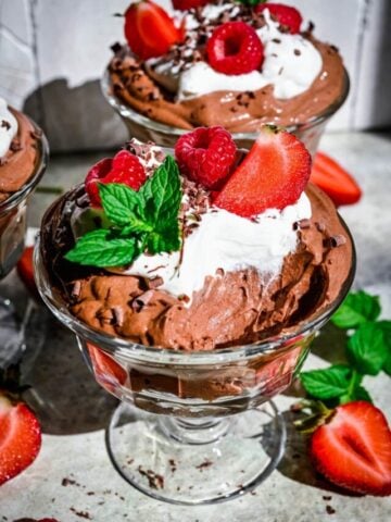Close up view of tofu chocolate mousse in jar with spoonful taken out.