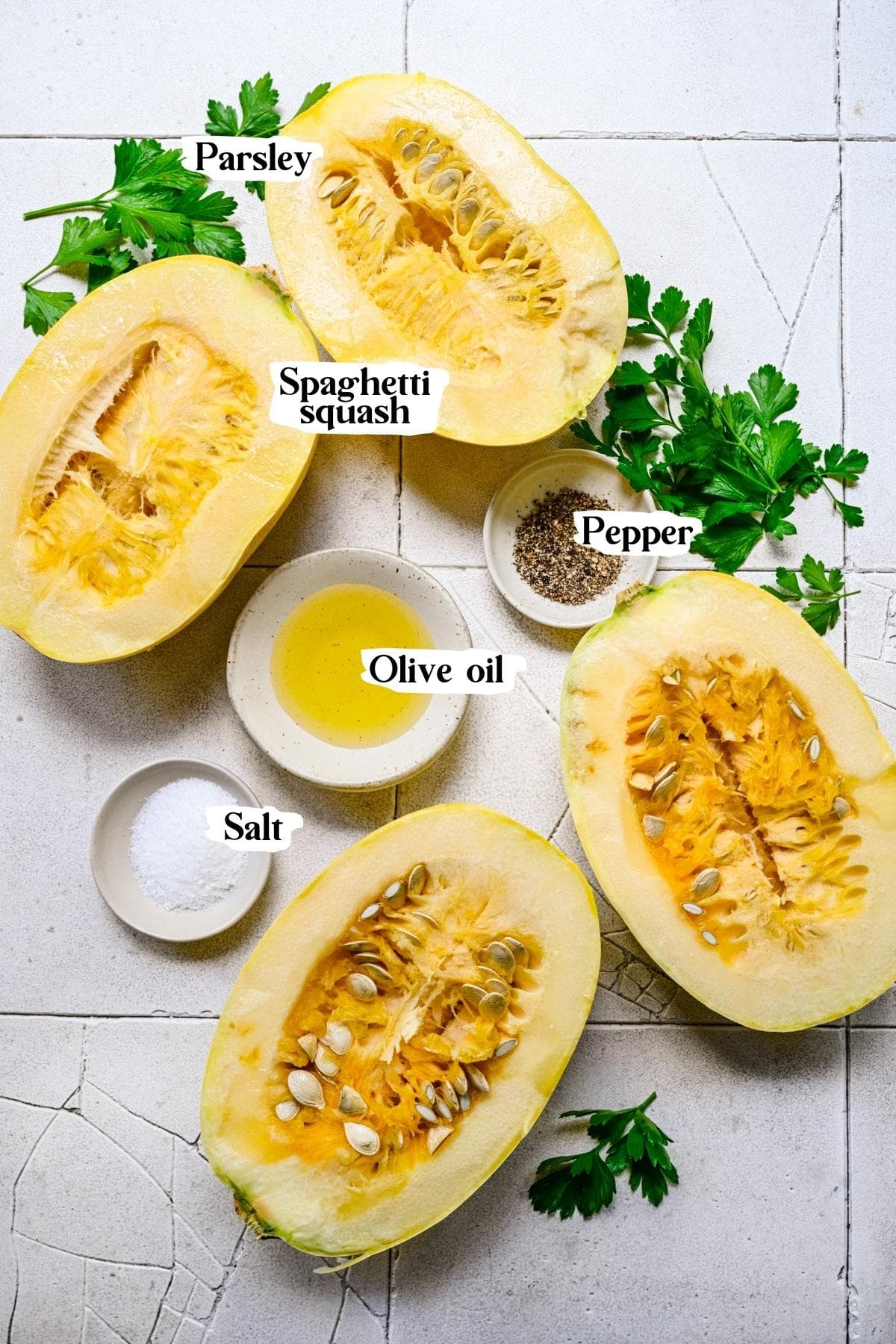 Overhead view of grilled spaghetti squash ingredients, including squash, salt, and pepper.