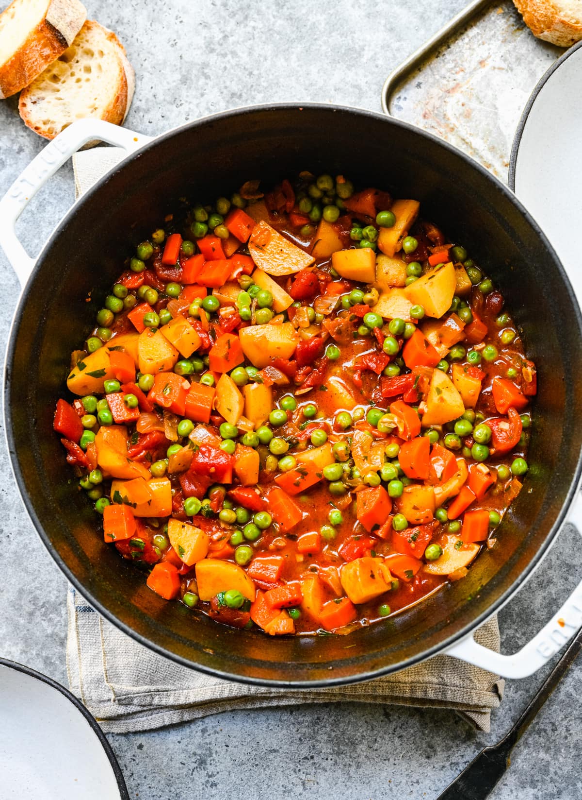 Overhead view of finished pea stew in a pot.