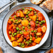 Overhead view of pea stew in a white bowl.