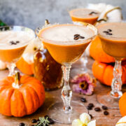 Close up of finished espresso martinis with pumpkins in background.