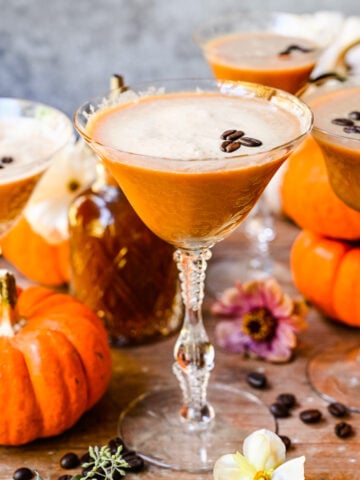 Close up of finished espresso martinis with pumpkins in background.